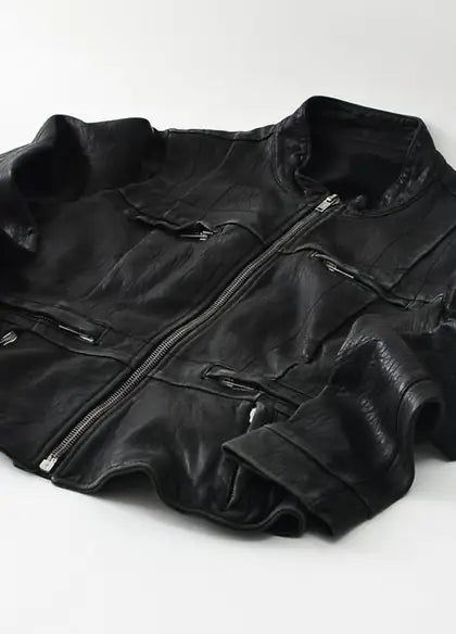 A cut leather jacket laid flat before assembly