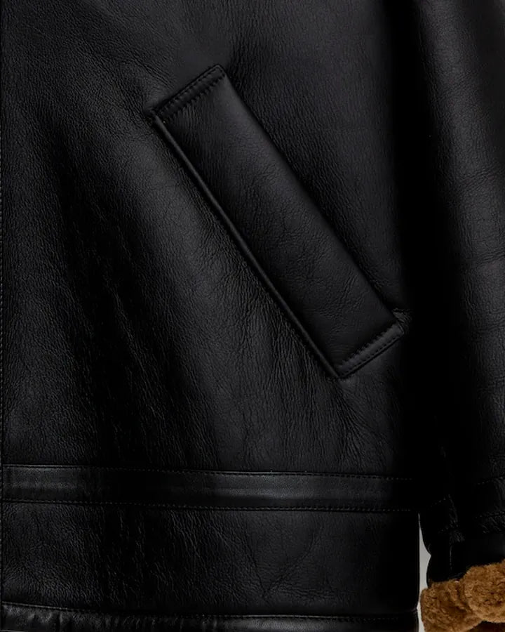 Macro detail of the welt pocket, hem seam and shearling cuff