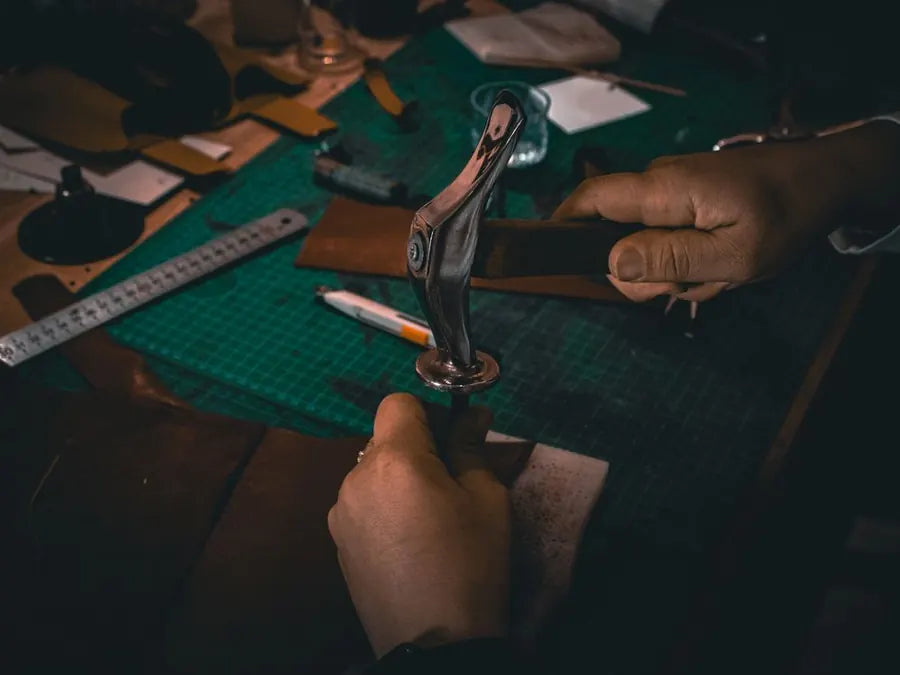 A cutter marking a pattern on leather with a knife and steel rule