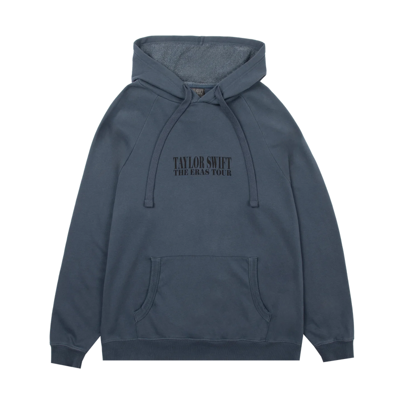 A slate blue-gray pullover hoodie with 'TAYLOR SWIFT THE ERAS TOUR' printed in black across the chest, featuring a front kangaroo pocket and drawstring hood, shown on a plain white background.