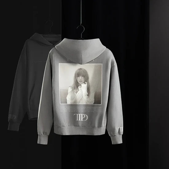 Gray hoodie with a printed design on the back against a black background